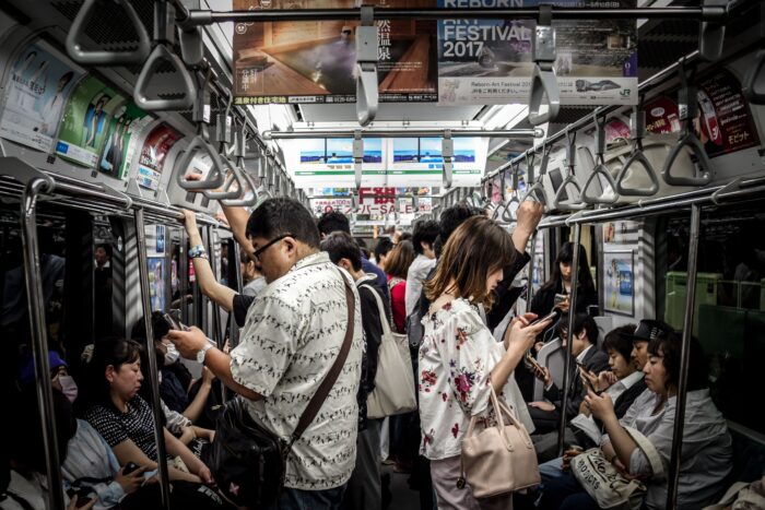 Crowded subway with people watching their phones
