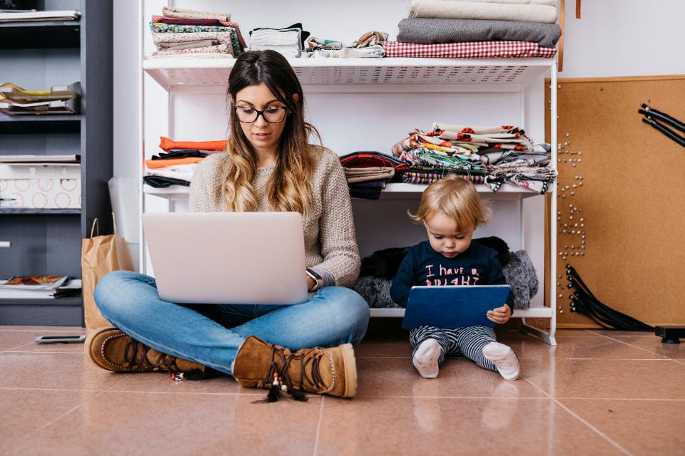 Mom and child with computers on floor